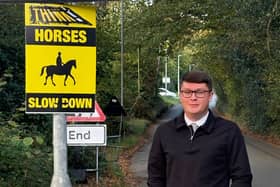Cllr Connor Winter by one of the new signs