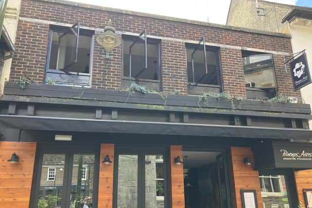 Windows on the first floor of the Buenos Aires Arentine Steakhouse restaurant in Market Square, Horsham, were left open as emergency crews left the scene of the fire. Photo: Sarah Page