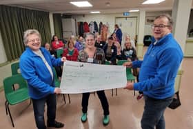 Clare Barber (centre) and Polegate  Sundowners WI presenting the cheque to  East Sussex Hearing
