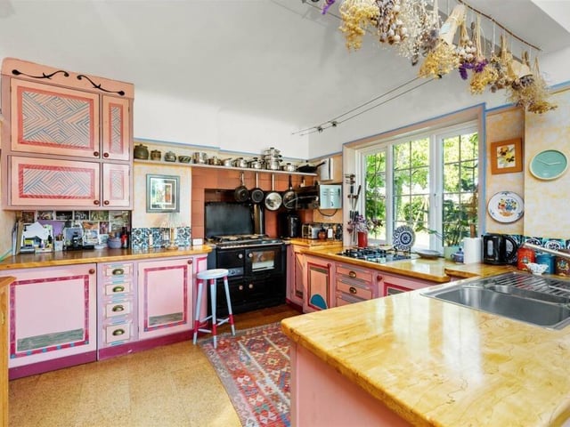The kitchen/dining room has handmade wooden units with original paint work, a Stanley range cooker and a two-ring gas and electric hob with other integrated appliances