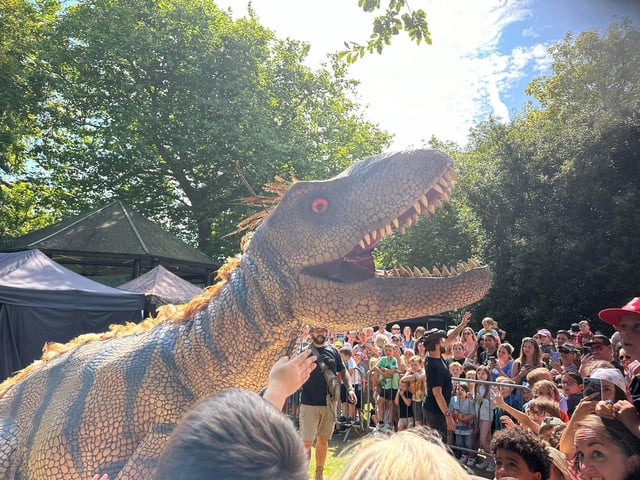 A T-Rex roars for the crowd.