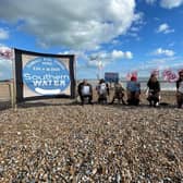 Campaigners from Extinction Rebellion and the Clean Water Action Group holding their protest on St Leonards beach