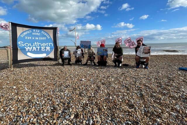 Campaigners from Extinction Rebellion and the Clean Water Action Group holding their protest on St Leonards beach