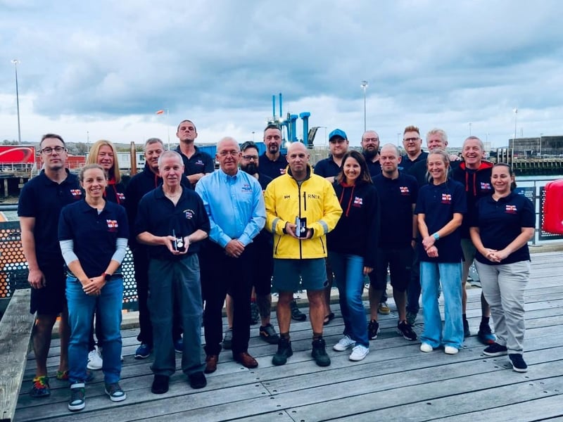 Newhaven Lifeboat crew and volunteers, October 2023. Back row, left to right: James Cox, Katherine Nash, Christopher Moore, Lewis Arnold (Coxswain), Rich White, Chris Glasspool, Ash Kristiansen, Alex Beckett, Adam Doughty (Launch Authority), Dan Pollard, John Simcock. Front row, left to right: Claire Townsend, Nick Gentry (receiving 40-year long service medal), Roger Cohen MBE (Lifeboat Operations Manager), Lee Blacknell (Second Coxswain, receiving 20-year long service medal), Jane Masey (Water Safety Officer), Danny Woodford, Jo Goode, Sam Briggs.
