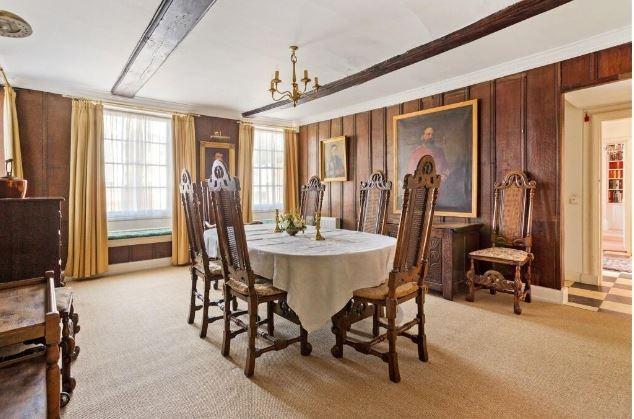 There is an impressive panelled dining room with an inglenook fireplace