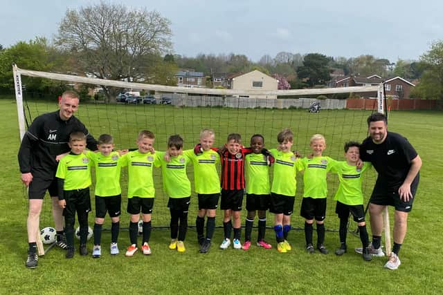 Lancing United Colts received a grant from UK Power Networks for new footballs, cones and a rain cover for the subs bench. Picture: UK Power Networks