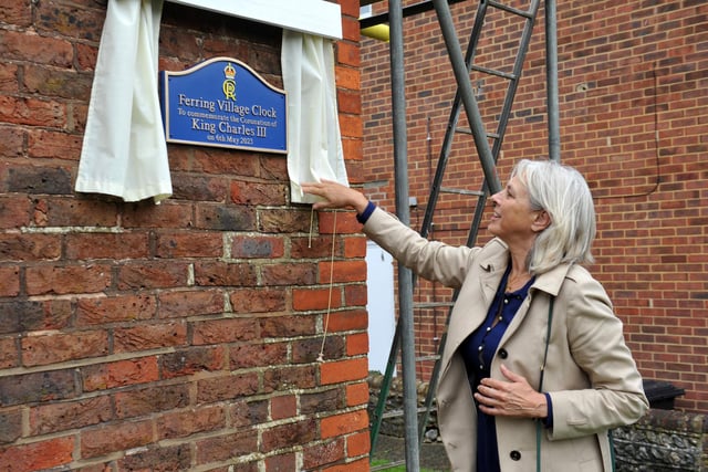 The Duchess of Norfolk, Georgina Fitzalan-Howard, unveils the plaque at Ferring Village Hall to mark the Coronation of King Charles III