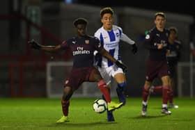 CRAWLEY, WEST SUSSEX - JANUARY 07:  Bukayo Saka of Arsenal is closed down by Hayden Roberts of Brighton during the match between Brighton & Hove Albion v Arsenal during the PL2 match at Checkatrade.com Stadium on January 7, 2019 in Crawley, West Sussex.  (Photo by David Price/Arsenal FC via Getty Images)