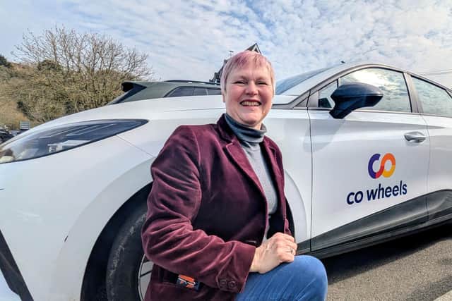 Cllr O'Brien pictured with a Co-wheels car