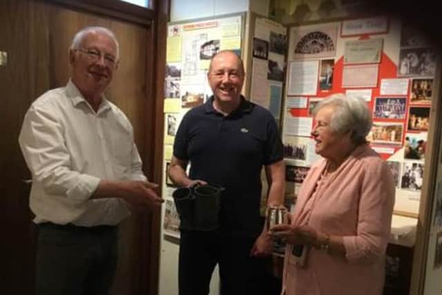 Janet Sawyer and her son Paul hand their donations to Andrew Woodfield, Steyning Museum’s curator of exhibitions