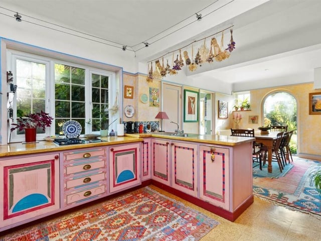 The kitchen/dining room has handmade wooden units with original paint work, a Stanley range cooker and a two-ring gas and electric hob with other integrated appliances