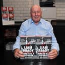 Liam Brady signs books in the Arsenal FC shop (Photo by David Price/Arsenal FC via Getty Images)