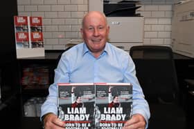 Liam Brady signs books in the Arsenal FC shop (Photo by David Price/Arsenal FC via Getty Images)