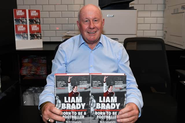 Liam Brady signs books in the Arsenal FC shop (Photo by David Price/Arsenal FC via Getty Images)