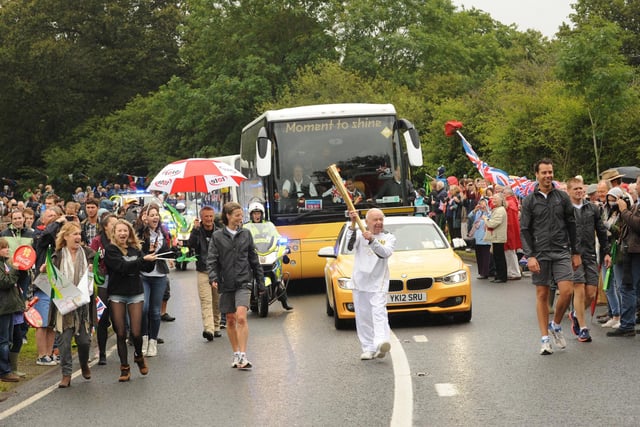 An historic moment for Paul Zetter as he carries the torch through Duncton