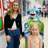 Children with Busta in Tesco beside the Recycle to Read Collection Bins