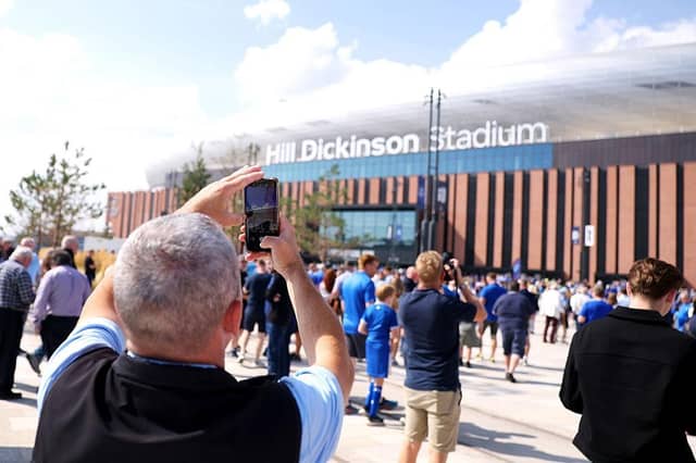 A fan takes a photo of the outside of the stadium on their mobile phone prior to the Premier League match between Everton and Brighton & Hove Albion at Hill Dickinson Stadium