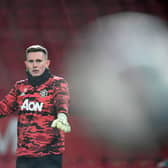Manchester United goalkeeper Dean Henderson warms up before the facing Manchester City at Old Trafford.