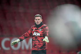 Manchester United goalkeeper Dean Henderson warms up before the facing Manchester City at Old Trafford.