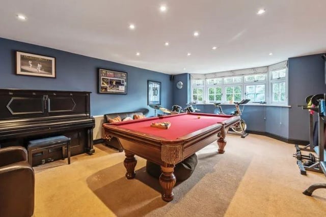A spacious family room has an internal door leading into the games room, both featuring bay windows.