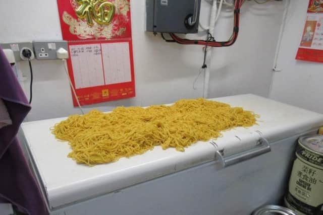 Lee Garden Takeaway in Horley, cooked noodles in direct contact with surface. Picture courtesy of Reigate & Banstead Borough Council