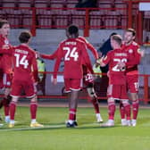 Crawley Town players celebrate with Jack Roles after his first goal for the club. Picture: Ed Medcalf