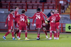 Crawley Town players celebrate with Jack Roles after his first goal for the club. Picture: Ed Medcalf