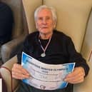 Proudly receiving a certificate and medal after weeks of fun, inclusive games and friendly competition.