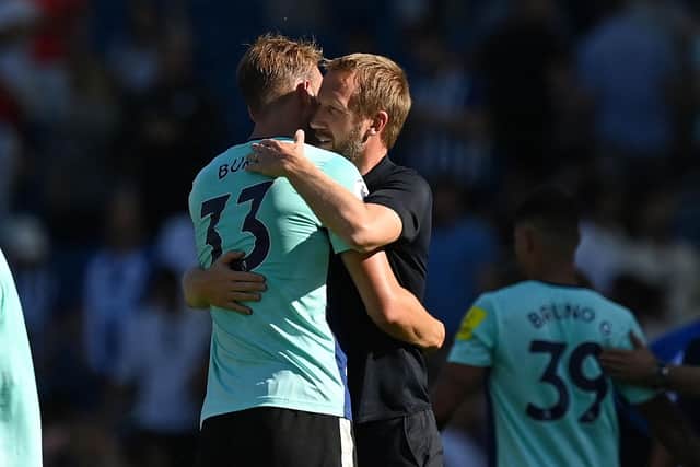 Brighton's manager Graham Potter embraces former defender Dan Burn, who impressed for Newcastle during the goalless draw at the Amex. (Photo by GLYN KIRK/AFP via Getty Images).