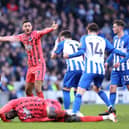 Referee Tony Harrington gives a red card to Billy Gilmour of Brighton for a foul on Amadou Onana of Everton (Photo by Warren Little/Getty Images)