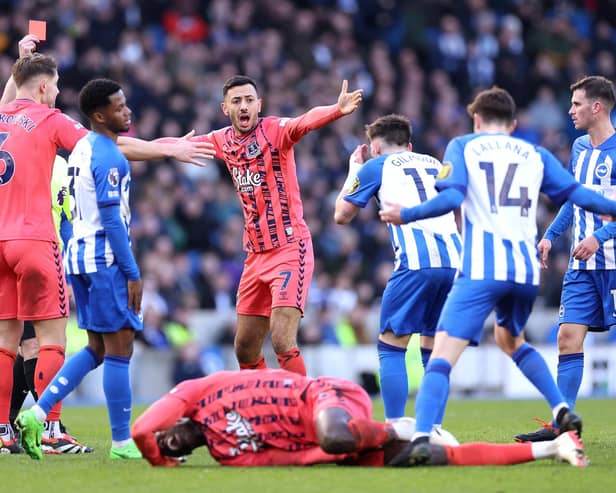Referee Tony Harrington gives a red card to Billy Gilmour of Brighton for a foul on Amadou Onana of Everton (Photo by Warren Little/Getty Images)
