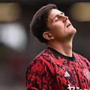 Manchester United's English defender Harry Maguire warms up ahead of the Premier League football match between Manchester United and Brighton and Hove Albion at Old Trafford