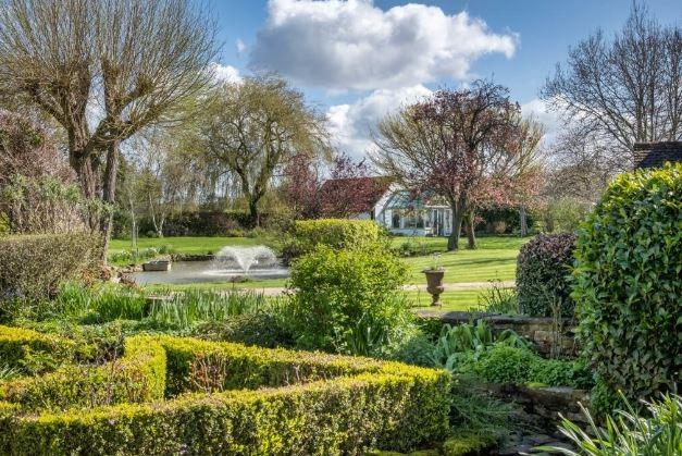 The formal gardens include a large lake and fountain