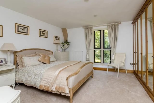 The spacious master bedroom benefits from built-in wardrobes and an en-suite shower room