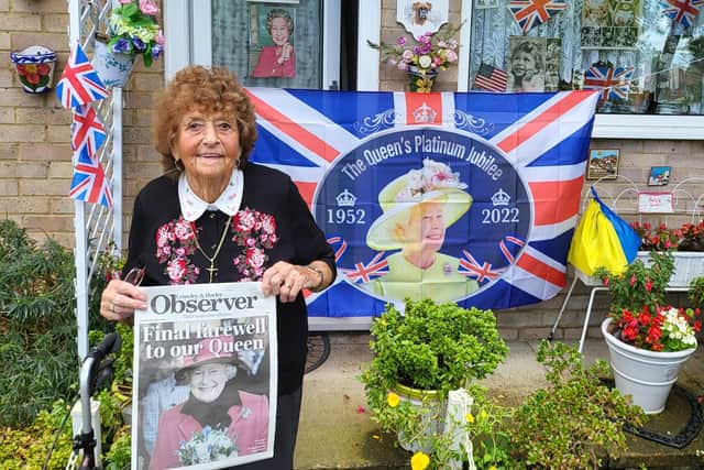 Betty Phillips outside her house in Gossops Green with her copy of this week's special edition of the Crawley Observer
