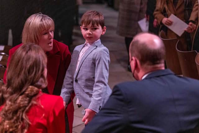 Britain's Prince William, Duke of Cambridge (R) and Britain's Catherine, Duchess of Cambridge (L) chat to Tony Hudgell, (C), a double amputee who raised more than £1.5 million for charity Evelina after being inspired by Captain Tom, during the Together At Christmas community carol service at Westminster Abbey in London on December 8, 2021. (Photo by Heathcliff O'Malley / POOL / AFP) (Photo by HEATHCLIFF O'MALLEY/POOL/AFP via Getty Images)