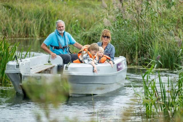 Visitor all aboard the 20 minute boat safari through the reedbeds at Arundel Wetland Centre