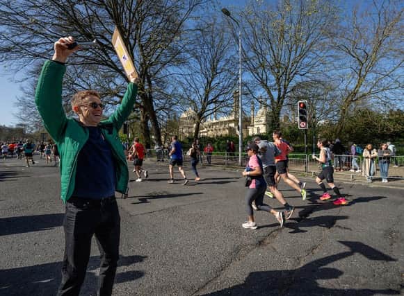 A supporter cheers on participants as they run past the Royal Pavilion during The Brighton Marathon on Sunday 7th April 2024.Photo: Andrew Baker for London Marathon EventsFor further information: media@londonmarathonevents.co.uk:Images from the 2024 Brighton Marathon