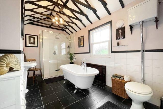 The property has a spectacular bathroom with a claw foot roll top bath, a double shower, a pedestal sink, and a traditional high level toilet, as well as an an additional separate toilet.