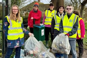 Volunteers pictured next to collected litter.