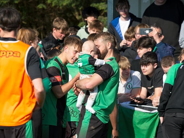 Burgess Hill Town players, fans and staff celebrate surviving in the Isthmian south east division at the end of their 0-0 draw with Beckenham