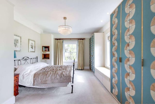 There are six bedrooms. The principal suite has wonderful southerly views and a range of bespoke wardrobes with walnut and silk detailing, a walk-in dressing room with walnut fittings, and a large re-fitted en suite bathroom