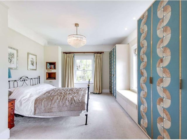 There are six bedrooms. The principal suite has wonderful southerly views and a range of bespoke wardrobes with walnut and silk detailing, a walk-in dressing room with walnut fittings, and a large re-fitted en suite bathroom