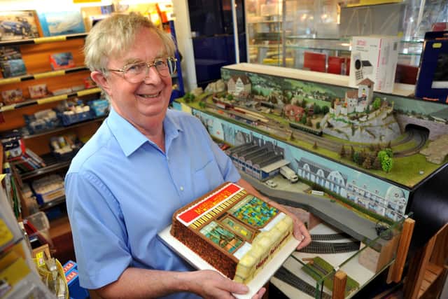 Brian Jackson in Morris Models in Lancing on his retirement, holding a cake made by Claire Sherriff, daughter of Brenda Edkins. Picture: S Robards SR2208273