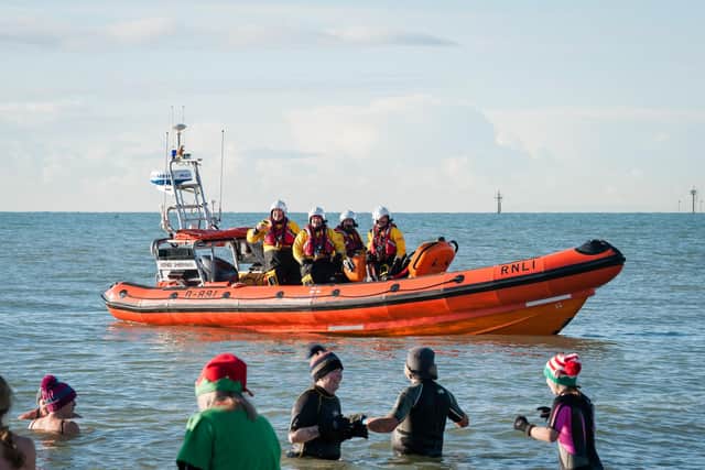 Littlehampton RNLI lifeboat crews look on as people took part in the December Dip last year. Picture: RNLI