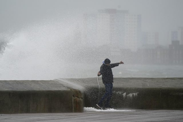 A person is sprayed by a wave as it crashes against the seafront in Southsea as Storm Barra hit. Picture: Andrew Matthews/PA Wire