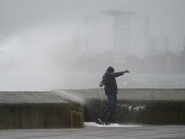A person is sprayed by a wave as it crashes against the seafront in Southsea as Storm Barra hit. Picture: Andrew Matthews/PA Wire