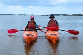 Couple smiling next to each other, while Sea Kayaking in Chichester Harbour