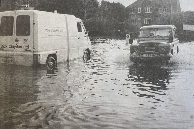 A van sits abandoned in the flooded rood.