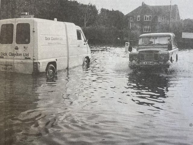 A van sits abandoned in the flooded rood.